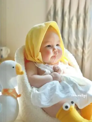Irresistibly adorable image of a baby with precious chubby cheeks