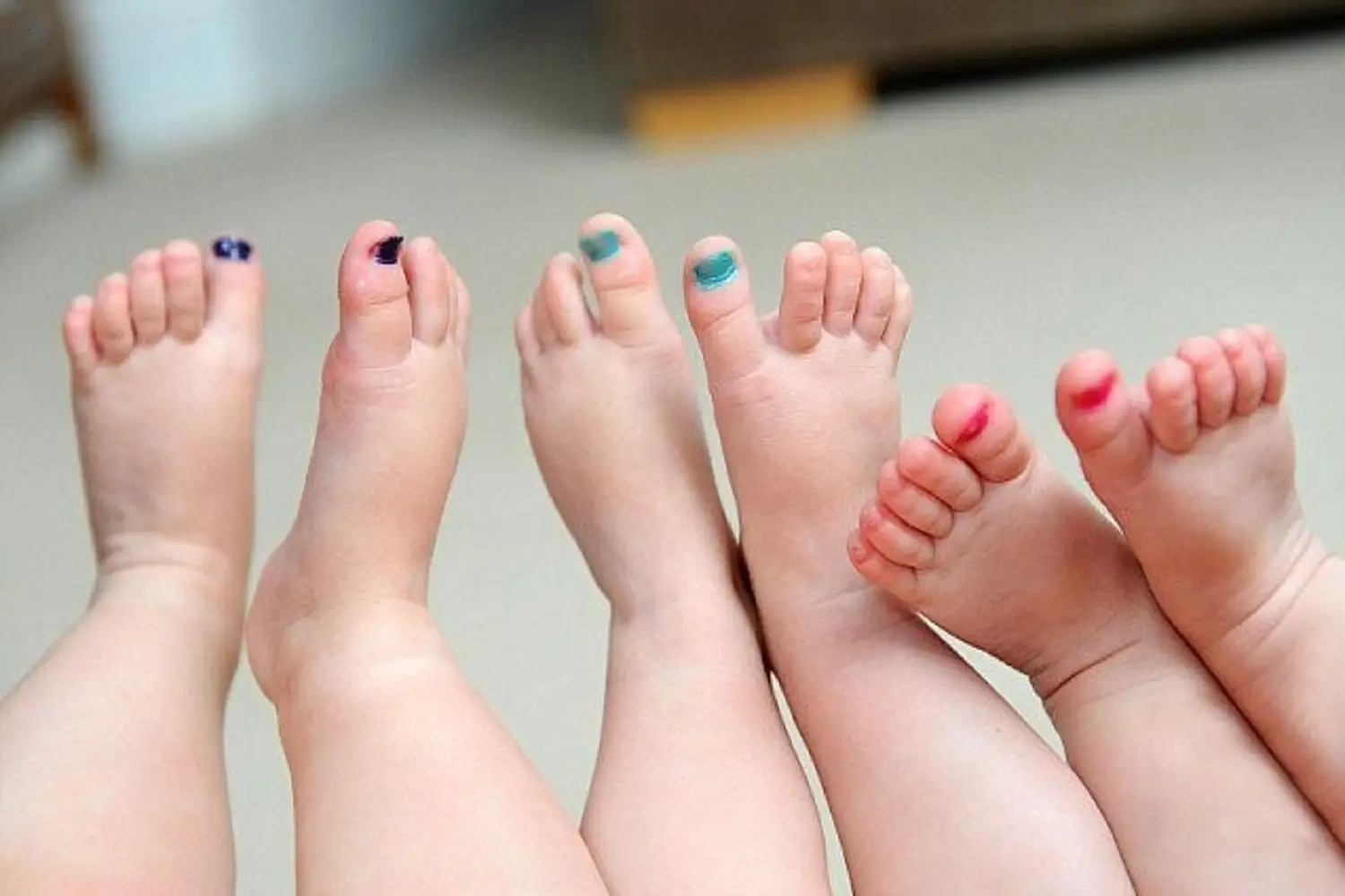 The primary method of distinguishing between their three identical offspring is the color of their toenails.