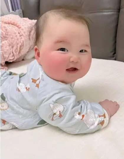 Irresistibly adorable image of a baby with precious chubby cheeks