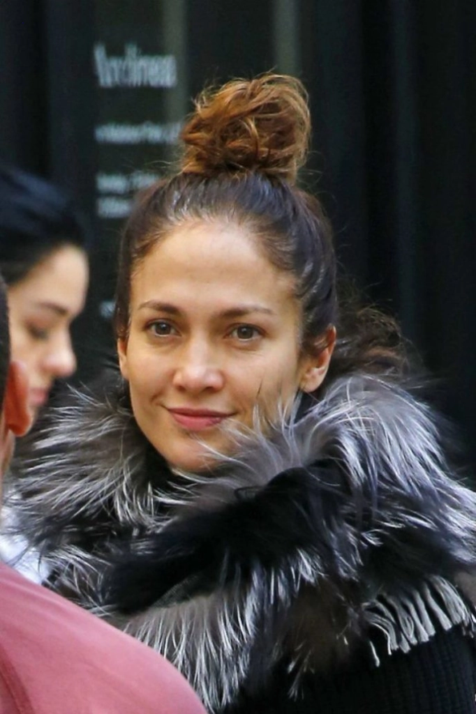 Without any makeup and wearing tights. Lopez was photographed with a bun on her head.