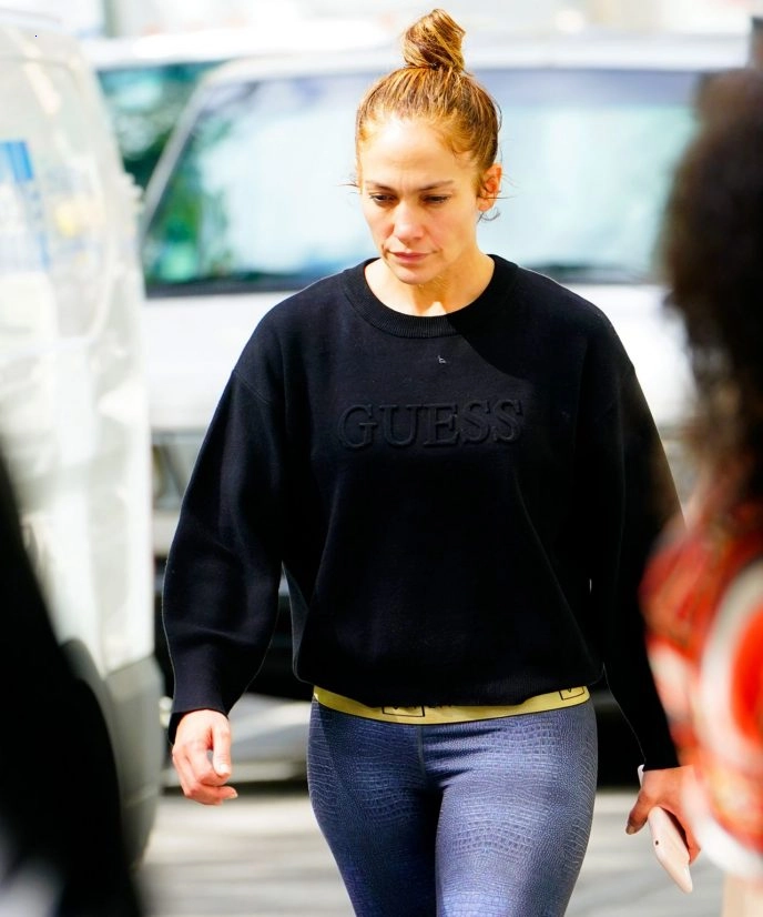 Without any makeup and wearing tights. Lopez was photographed with a bun on her head.