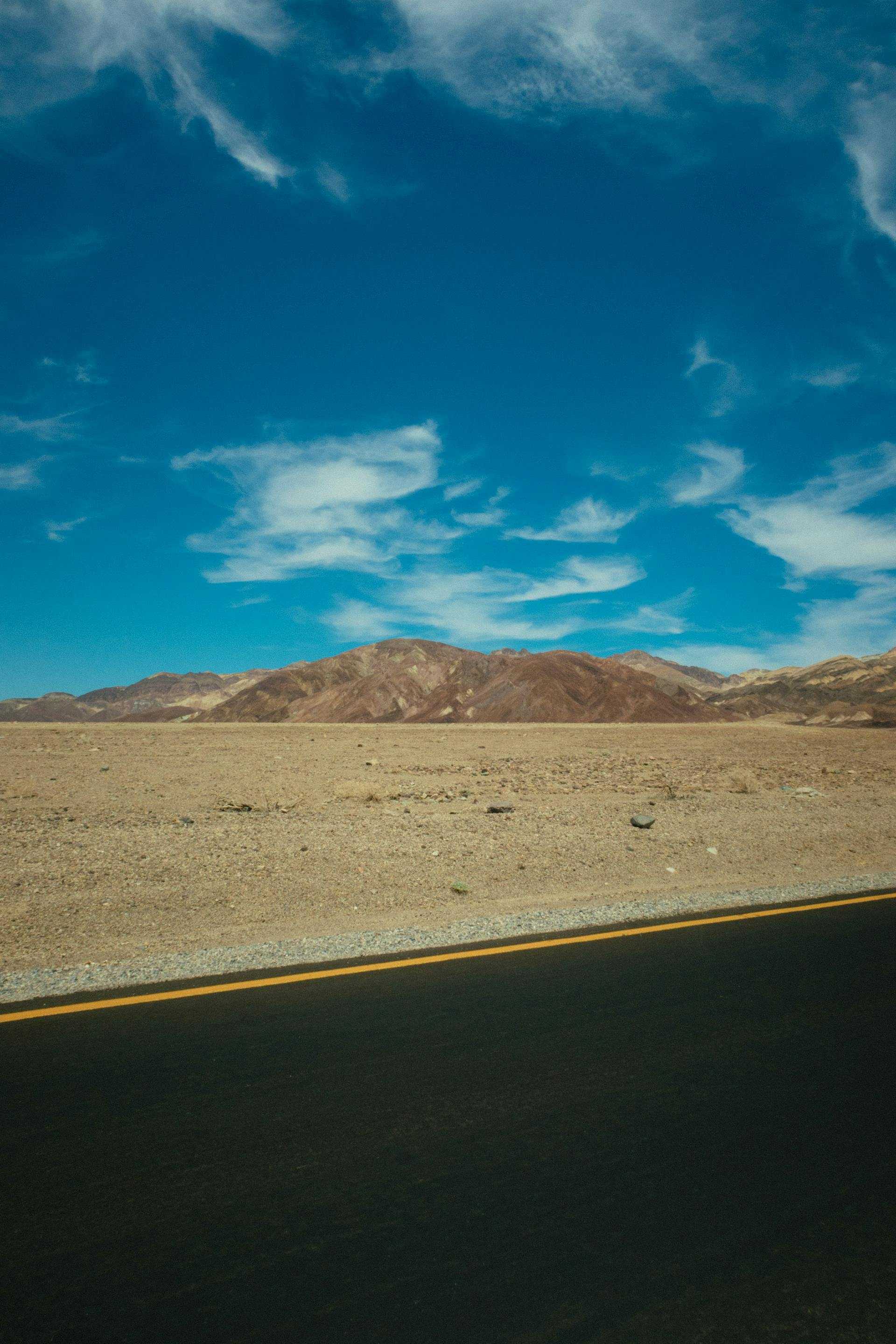 Barren fields next to a road | Source: Pexels